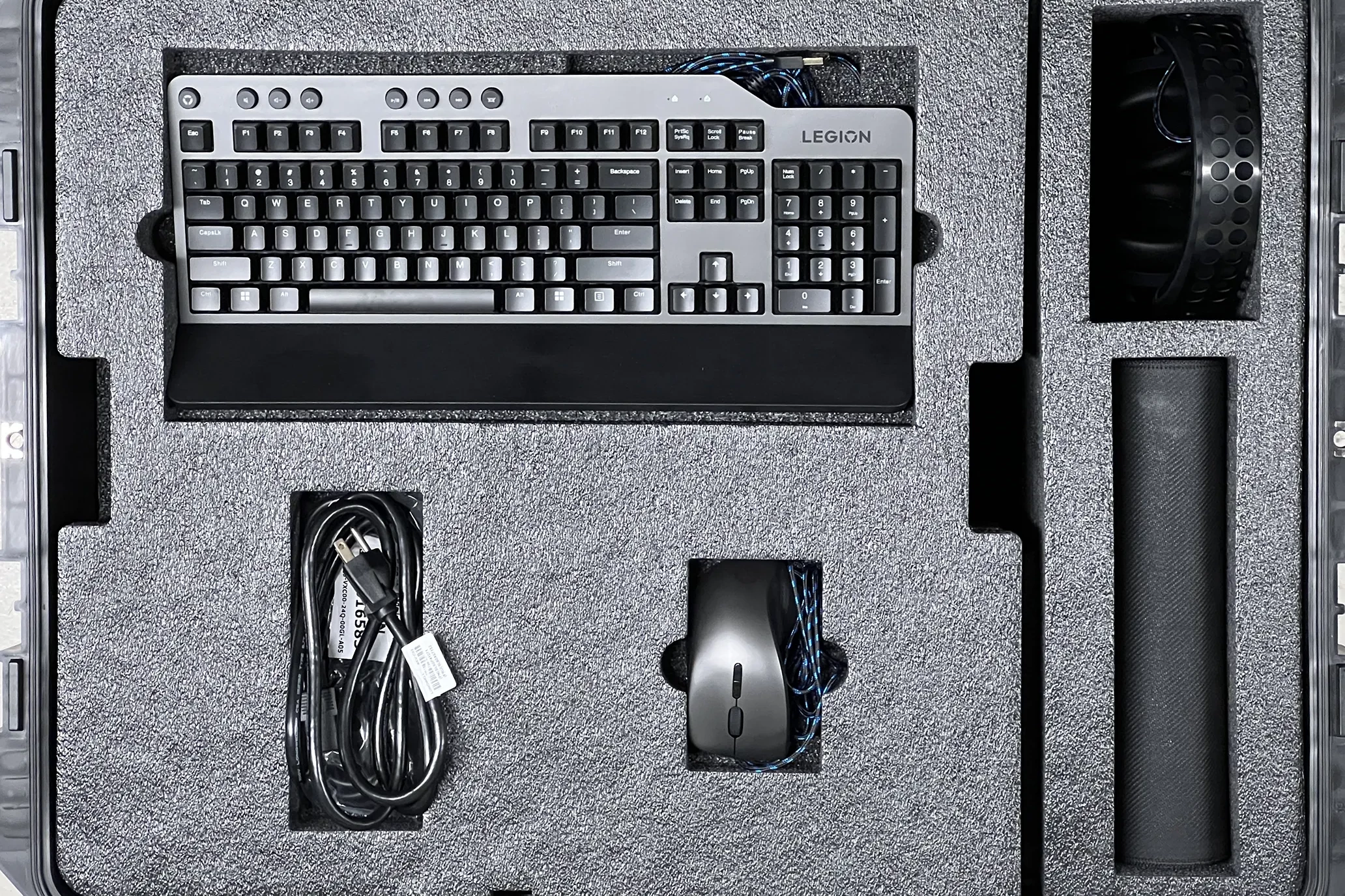 A customised foam insert with a keyboard, mouse & cables