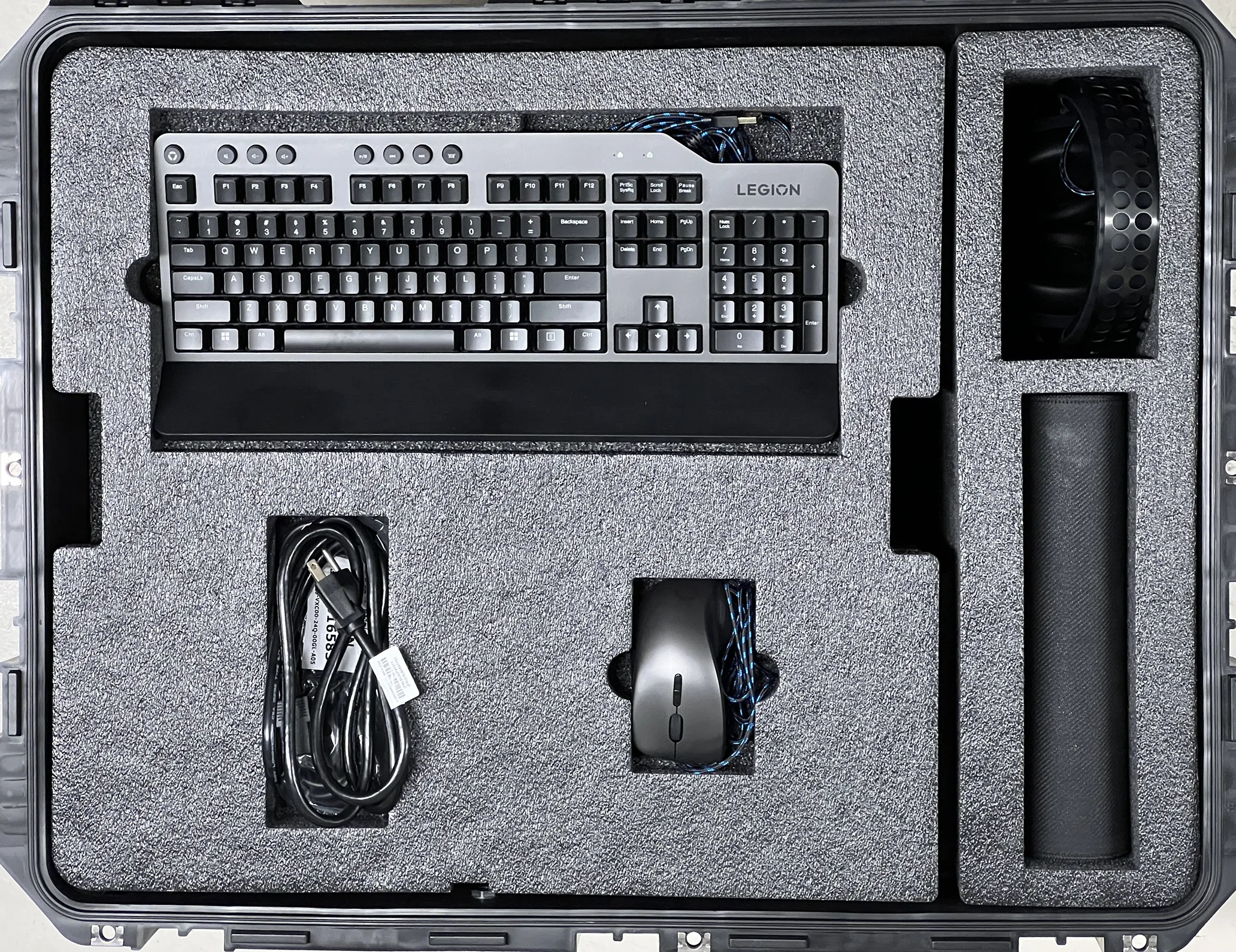 A customised foam insert with a keyboard, mouse & cables