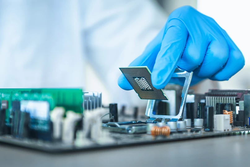 Photo of a lab technician working on electronic data port inserting a chip