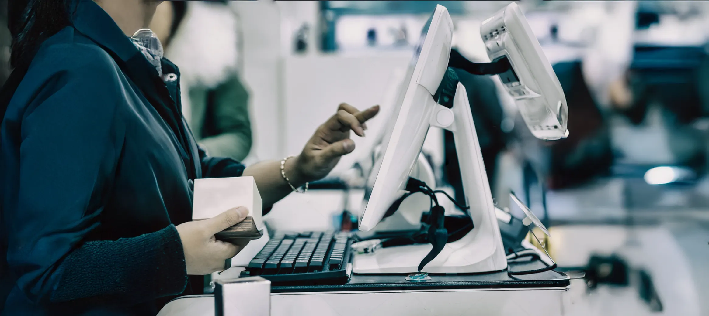 Photo of a woman processing an order at a POS terminal